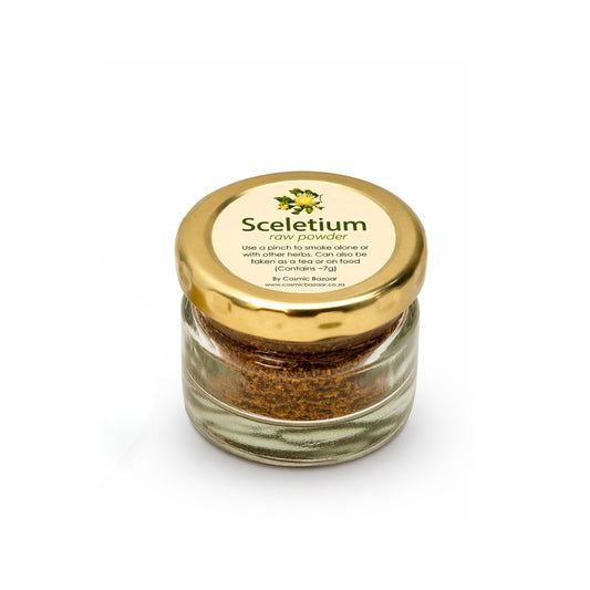 Glass jar with gold lid containing raw Sceletium powder on a white background